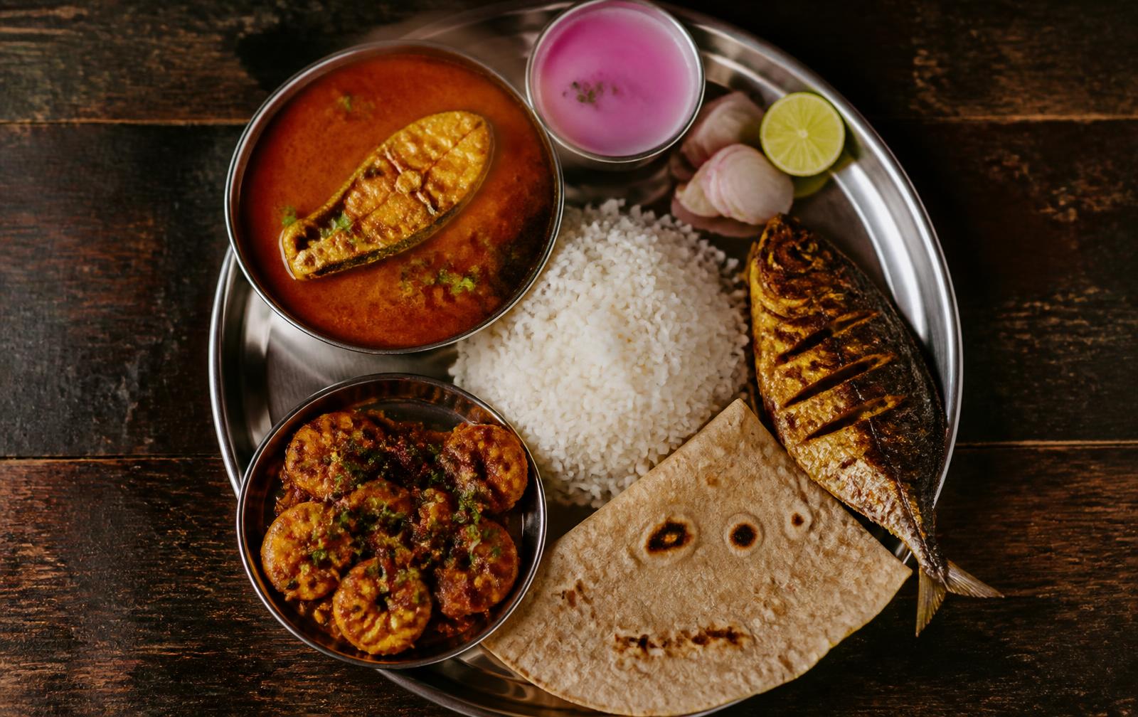 Konkani seafood thali with fish curry, tawa fried bangda, rice and solkadhi